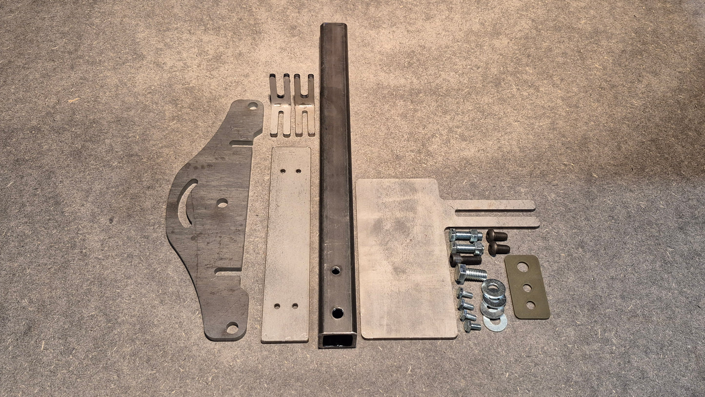 D Plate next to tooling arm assembly in raw metal